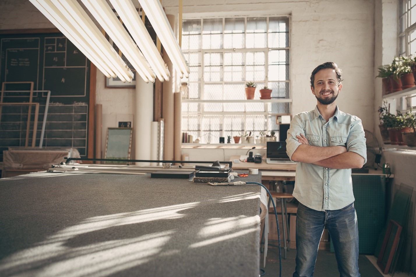 A new business owner standing in an open office space.
